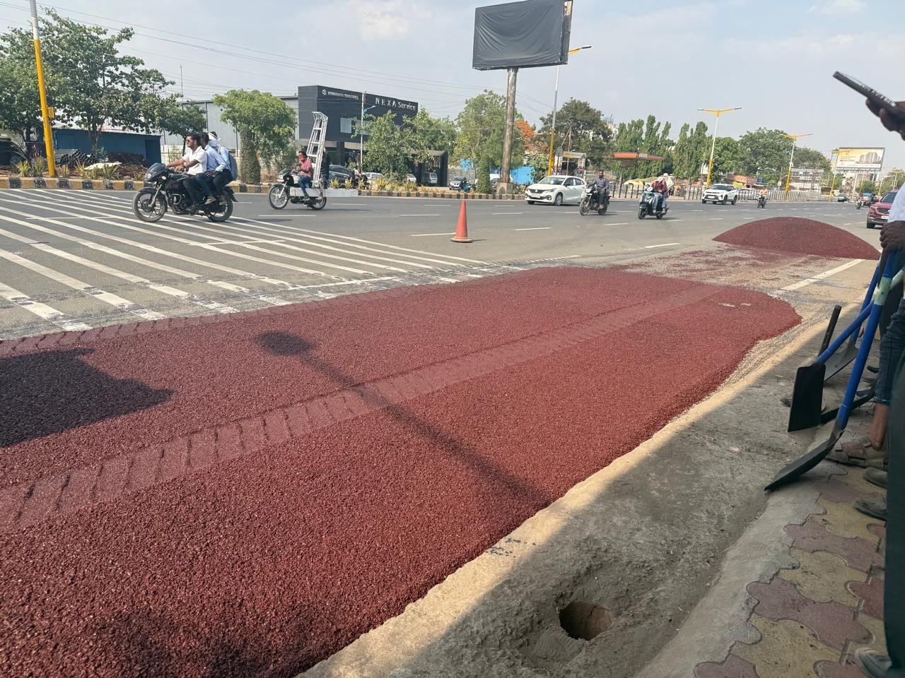 Freshly laid red coloured bitumen lane at a city junction