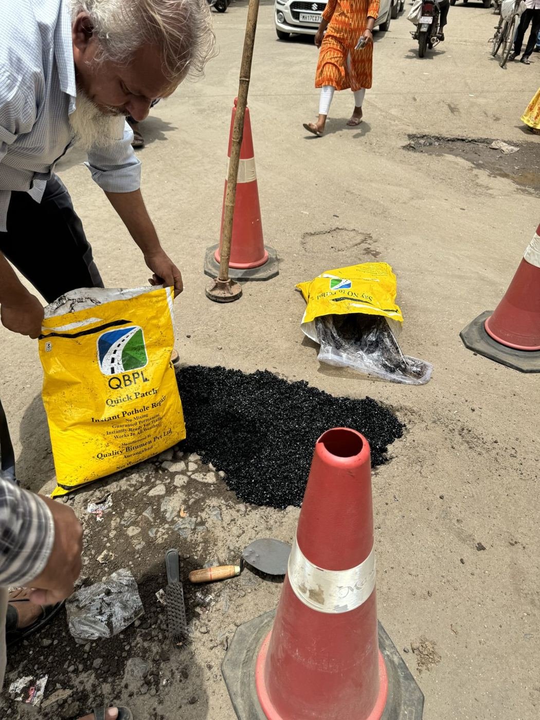 Worker pouring Quick Patch from a bag